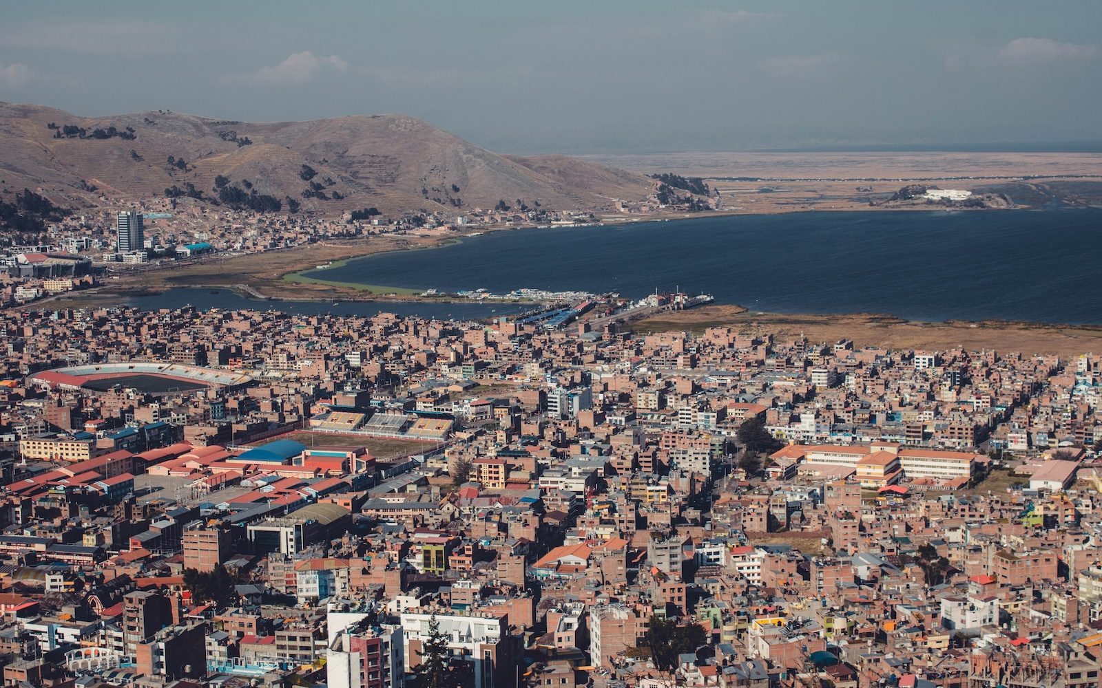 aerial view of city buildings near body of water during daytime